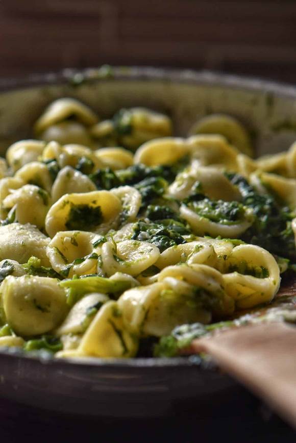 Close up of the pasta with the broccoli rabe in a pan.